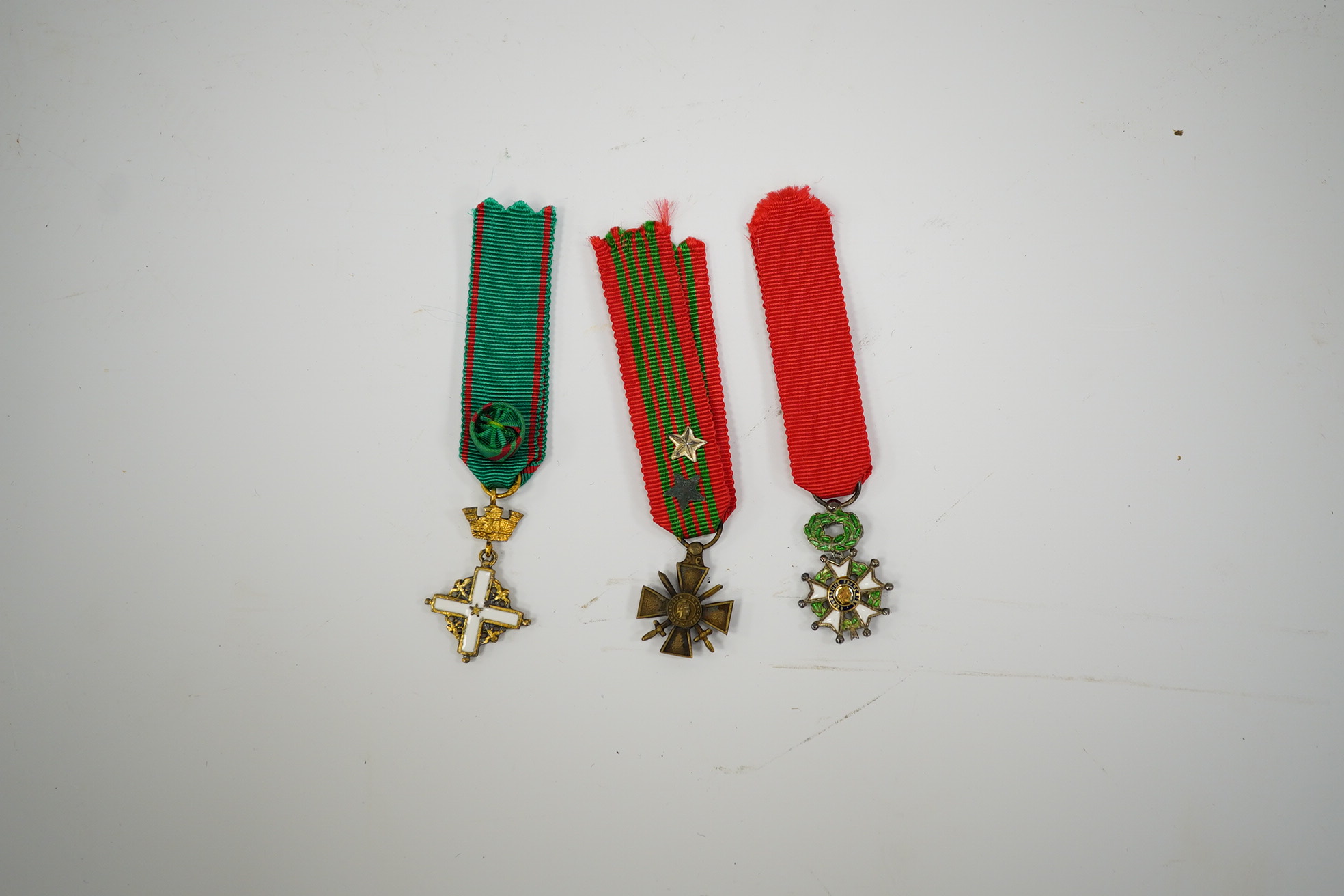 A framed medal group; Legion D'Honneur France, a British Cross, Italian order of Merit and Croix De Guerre with related book; La Legion d’Honneur by Jean Daniel, plus some related paperwork, three related medal miniature